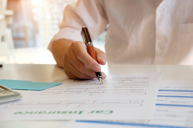 a man draws up documents for a car