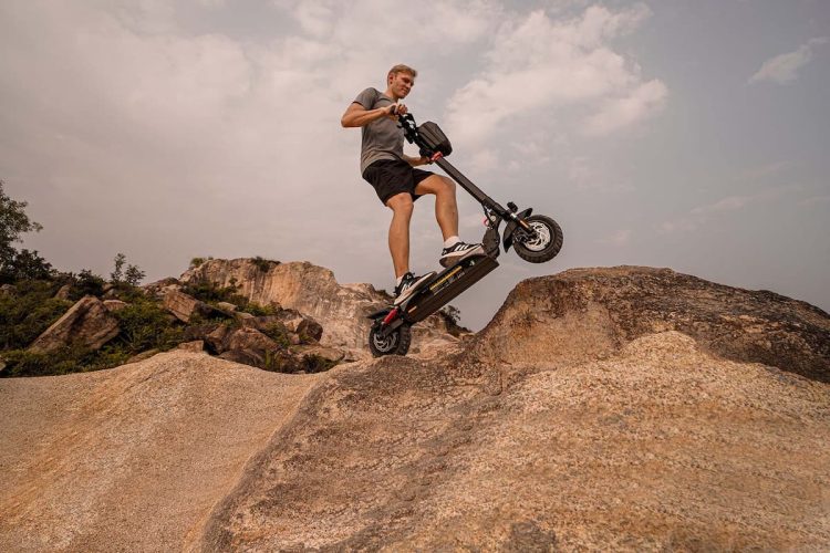 person standing on circooter bike