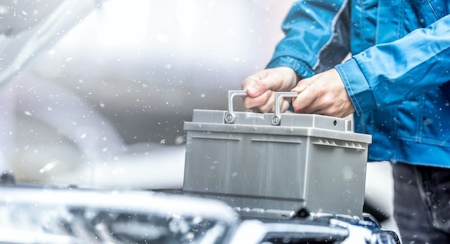 person holding car battery