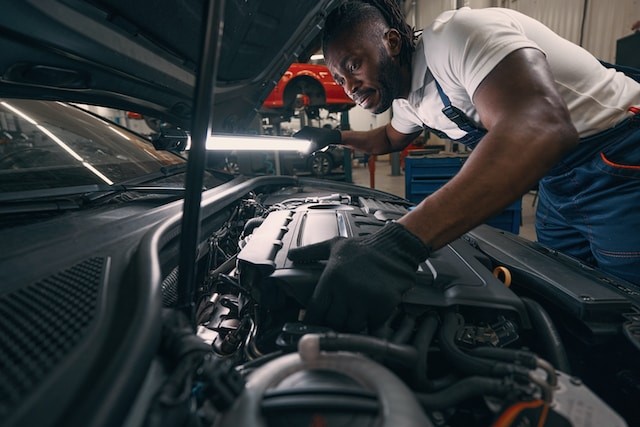 person lighting the engine of the car