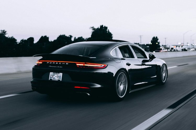 running-black-porsche-sedan